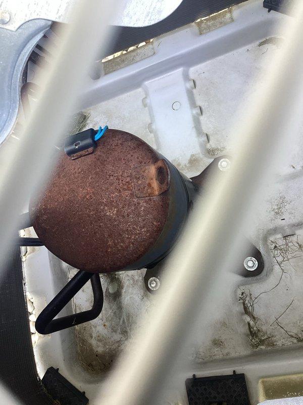 # HVAC Service Report

Responded to no cooling complaint on Bryant unit less than 10 years old. Upon inspection, discovered severely corroded blower motor housing with extensive rust deterioration affecting primary air handling components. Noted significant biological growth including algae and mold accumulation throughout drain pan and interior housing, indicating prolonged moisture exposure and inadequate drainage. Observed compromised condensate management system with visible standing water contamination. 

Measured clearance specifications and documented component deterioration. The advanced corrosion state of the blower assembly and associated electrical connections presented operational safety concerns. Identified wiring harness with visible corrosion near moisture-affected areas. Equipment exhibited conditions inconsistent with stated age, suggesting environmental factors or installation deficiencies accelerating degradation. 

Recommended complete blower motor assembly replacem