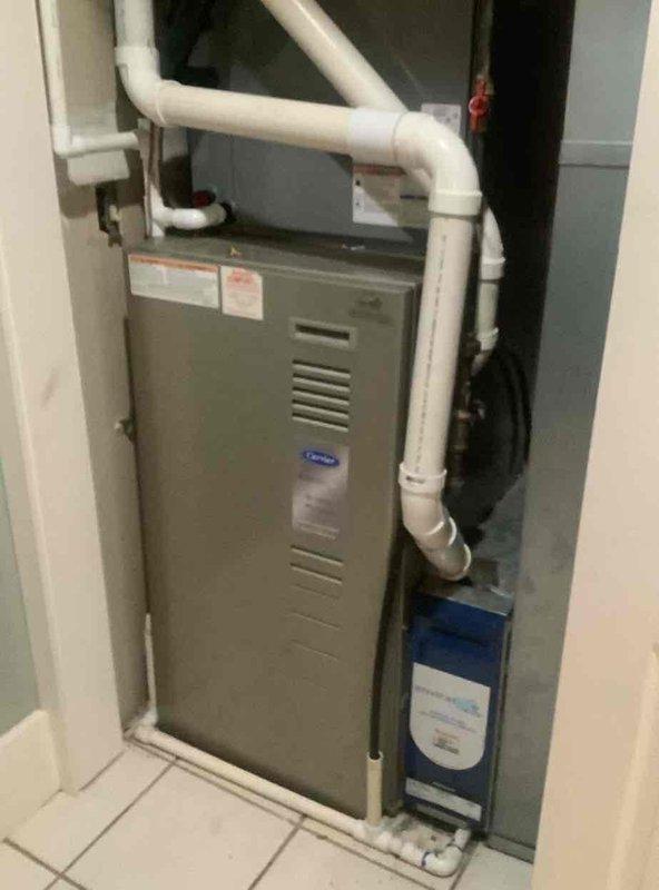 Completed monthly basic cooling maintenance visit on residential HVAC system. Inspected furnace unit with integrated cooling components, verified thermostat operation showing active alert notification with system holding at 73°F and set point of 71°F. Documented equipment condition including PVC venting configuration and lower filter housing, confirmed system operational status and proper thermostat communication.