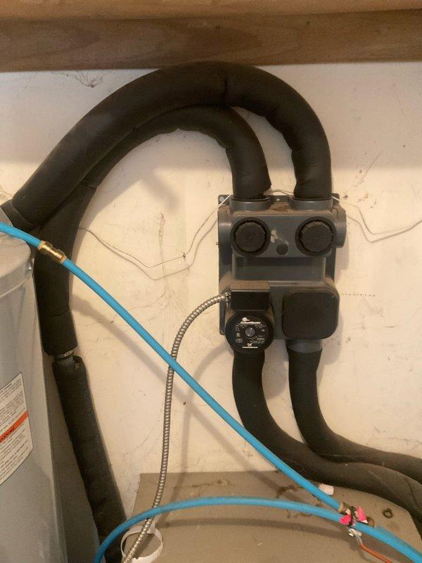 Conducted comfort consultation and system assessment for newly occupied residence with existing split geothermal system. Evaluated current Ducane air handler installation in closet space and discussed options for conversion to gas furnace with split geo configuration or dual fuel high-efficiency system. Assessed feasibility of relocating equipment down hallway to optimize space utilization. Documented existing system components including PVC condensate lines, metallic ductwork connections, and geothermal loop connections with valve assembly and flexible hoses. Prepared full system replacement estimate with expedited timeline for implementation.