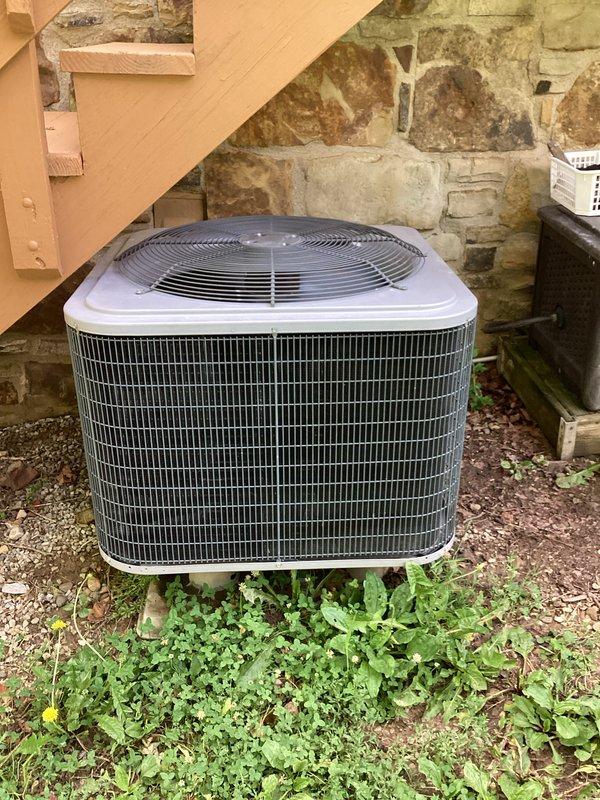 Completed routine HVAC maintenance on a residential cooling system, which included replacing the air filter as part of the basic preventive maintenance service. Inspected the outdoor condenser unit located beneath an elevated structure and verified the thermostat operation, confirming the system was cooling properly with the indoor temperature matching the setpoint of 75°F in cooling mode with the fan set to auto.