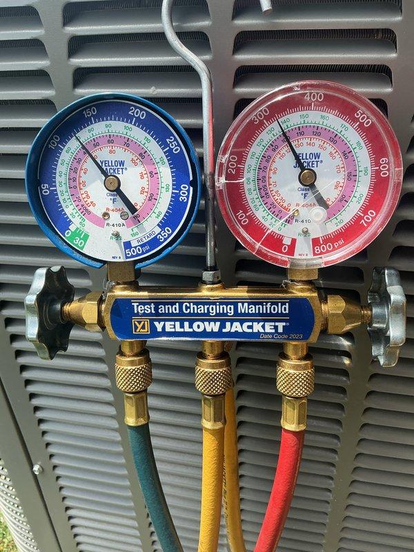 Completed monthly HVAC maintenance on cooling system including inspection of air handler unit with Honeywell Home controls and associated components. Performed refrigerant pressure diagnostics using Yellow Jacket manifold gauge set, verifying system pressures within manufacturer specifications. Replaced 20x20x4 air filter, inspected condensate drainage system with PVC piping configuration, and confirmed all equipment labels and safety placards remain intact and legible for proper system identification.