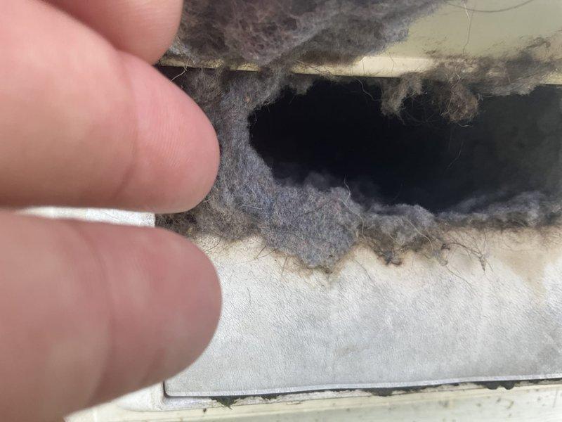 Performed comprehensive duct and dryer vent cleaning service at residential property. Upon inspection, discovered severely compromised air filter with significant structural damage, including large tear in filtration media and extensive accumulation of dust, debris, and lint indicating extended service life without replacement. Cleaned ceiling-mounted return air grille and accessible ductwork, removing accumulated contaminants from louvers and interior passages. Documented pre-service conditions showing filter deterioration and contamination levels. Recommended immediate filter replacement to restore proper airflow and system efficiency.