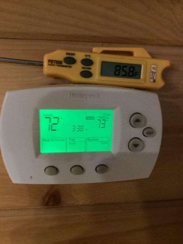 Responded to no cooling call on 6-9 year old Carrier central air system. Upon arrival, found thermostat set to cooling mode displaying 72°F setpoint while ambient temperature measured 85.8°F, confirming lack of cooling. Performed diagnostic evaluation of furnace and air handler system in basement installation. Inspected all electrical connections, refrigerant lines, condensate drainage, and ductwork connections. System components appeared properly installed with appropriate ventilation and gas line configurations intact. Identified cooling system malfunction and completed necessary repairs to restore proper operation.