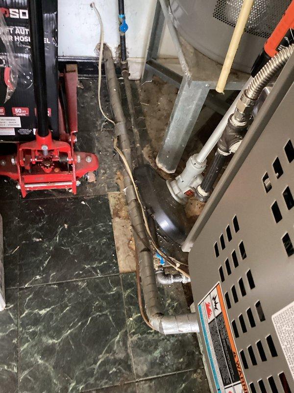 Responded to no cooling complaint on 25-year-old air conditioning system blowing room temperature air. Upon arrival, performed complete system diagnostic including visual inspection of indoor and outdoor equipment. Inspected condensing unit exterior components, refrigerant line sets, and electrical connections. Evaluated indoor air handler components, ductwork connections, and airflow pathways. Documented existing system conditions with photographic evidence showing aged equipment, piping configurations, and overall installation setup. Based on system age and operational assessment, provided customer with findings and recommended options for repair versus replacement considerations given the unit's service life expectancy.