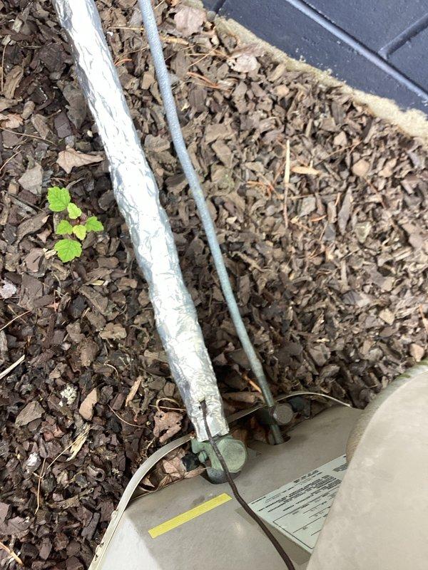 Responded to no cooling complaint on 25-year-old air conditioning system blowing room temperature air. Upon arrival, performed complete system diagnostic including visual inspection of indoor and outdoor equipment. Inspected condensing unit exterior components, refrigerant line sets, and electrical connections. Evaluated indoor air handler components, ductwork connections, and airflow pathways. Documented existing system conditions with photographic evidence showing aged equipment, piping configurations, and overall installation setup. Based on system age and operational assessment, provided customer with findings and recommended options for repair versus replacement considerations given the unit's service life expectancy.