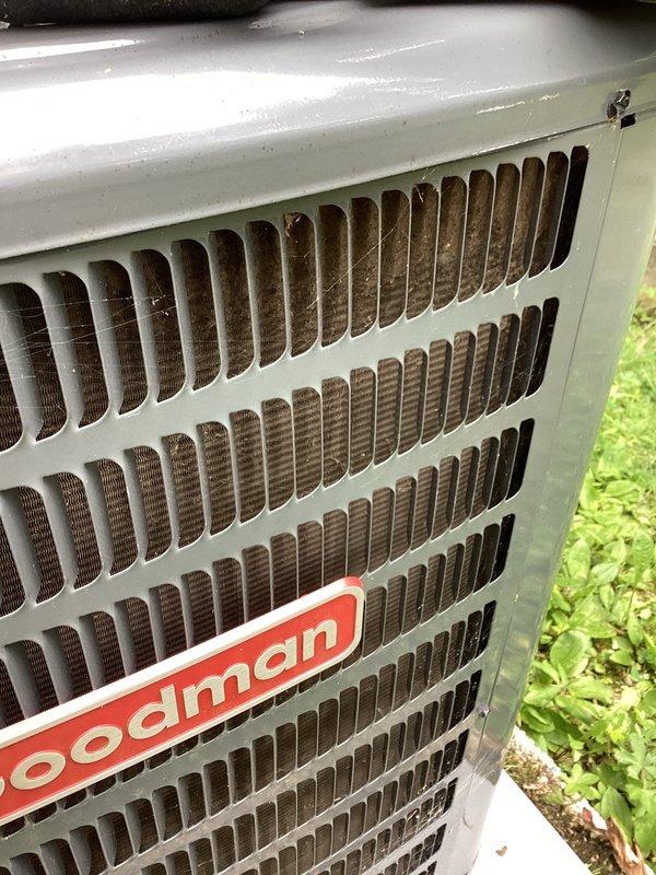 Responded to callback for Goodman air conditioning system failing to maintain setpoint temperature. Unit set to 68°F but space temperature reading 72°F. Previous technician had implemented temporary repair measure. Performed diagnostic evaluation of outdoor condenser unit and indoor thermostat operation. Documented system conditions with photos showing exterior condenser unit and thermostat display confirming 4-degree temperature differential between setpoint and actual room temperature. Further assessment required to identify root cause of cooling deficiency and determine permanent repair solution.