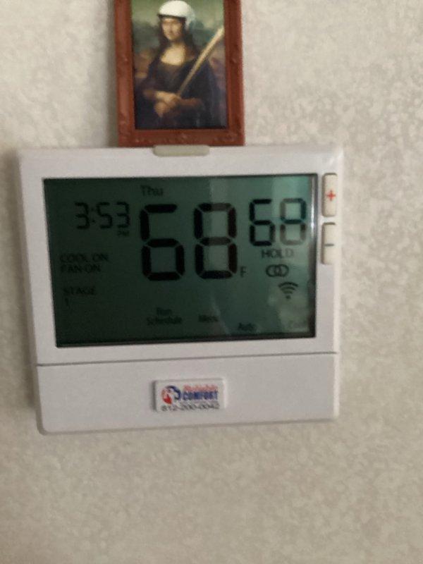 Responded to callback for Goodman air conditioning system failing to maintain setpoint temperature. Unit set to 68°F but space temperature reading 72°F. Previous technician had implemented temporary repair measure. Performed diagnostic evaluation of outdoor condenser unit and indoor thermostat operation. Documented system conditions with photos showing exterior condenser unit and thermostat display confirming 4-degree temperature differential between setpoint and actual room temperature. Further assessment required to identify root cause of cooling deficiency and determine permanent repair solution.