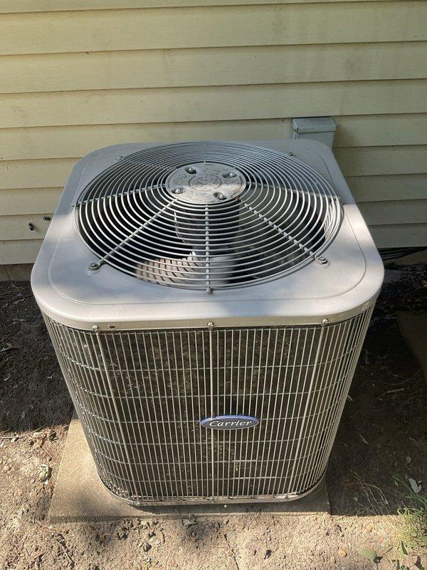 Conducted comprehensive assessment of aging residential HVAC system for replacement estimate. Evaluated outdoor Carrier brand condenser unit showing significant age-related wear, surface oxidation, and accumulated environmental debris consistent with over ten years of operation. Documented indoor air handler equipment located in utility closet alongside water heater, photographing existing system configuration and spatial constraints for replacement planning. Provided detailed replacement recommendations for complete air conditioning system upgrade to improve efficiency and reliability.