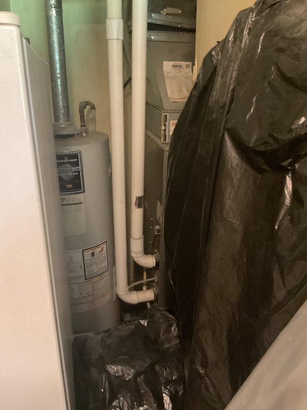 Conducted comprehensive assessment of aging residential HVAC system for replacement estimate. Evaluated outdoor Carrier brand condenser unit showing significant age-related wear, surface oxidation, and accumulated environmental debris consistent with over ten years of operation. Documented indoor air handler equipment located in utility closet alongside water heater, photographing existing system configuration and spatial constraints for replacement planning. Provided detailed replacement recommendations for complete air conditioning system upgrade to improve efficiency and reliability.
