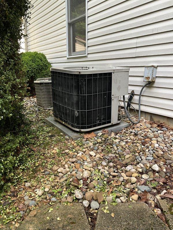 Conducted comprehensive assessment of 30-year-old HVAC system serving 2560 square foot residence with basement and first floor coverage. Evaluated existing 3-ton air conditioning condenser unit located on exterior gravel pad and 100,000 BTU natural gas furnace with 90%+ efficiency rating positioned in basement mechanical room. Documented current equipment configuration including ductwork routing, refrigerant line connections, electrical disconnect, and condensate drainage. Inspected furnace cabinet condition, heat exchanger accessibility, and ventilation duct connections with reflective insulation. Assessed outdoor condenser unit placement, airflow clearances, and electrical service components. Photographed existing installation showing equipment age, mounting configurations, and utility room layout with water heater proximity. Provided detailed replacement estimate for complete HVAC system upgrade to address non-operational air conditioning and aging equipment infrastructure requiring