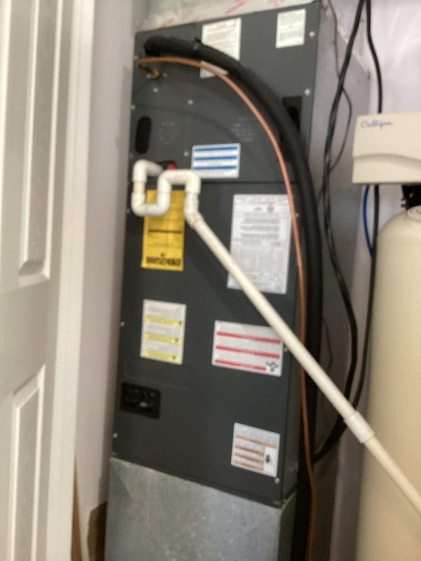 Responded to no cooling complaint on residential air conditioning system. Performed diagnostic inspection of air handler unit, accessed electrical compartment and inspected capacitor with multiple wire connections and terminals. Provided on-site assessment and repair recommendations to property owner for decision.