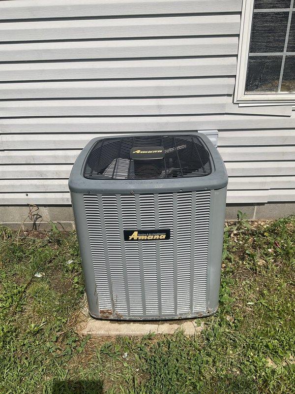 Responded to service call for non-operational air conditioning system with damaged refrigerant line caused by pet damage to outdoor condensing unit. Upon inspection, found Amana brand condenser with compromised refrigerant line requiring system replacement. Provided comprehensive estimate for complete HVAC system replacement including new outdoor condensing unit and compatible indoor air handler to replace existing aged furnace system showing significant wear and dust accumulation.