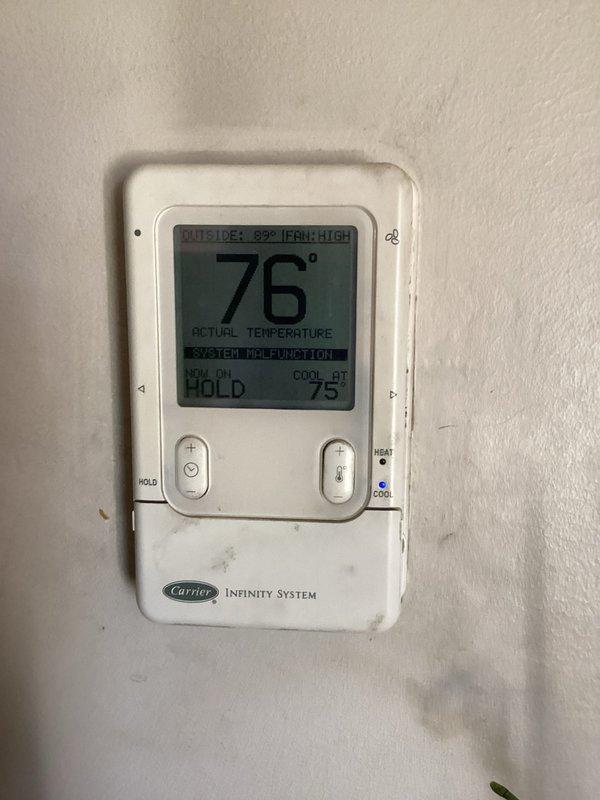 Responded to service call for AC not cooling properly and unusual odor. Upon arrival, found Carrier Infinity System thermostat displaying "SYSTEM MALFUNCTION" error with unit running but failing to reach setpoint of 75°F, with actual temperature reading 76°F and outside temperature at 89°F. Diagnosed system malfunction, cleared error codes, and restored proper cooling operation. Verified thermostat communication with air handler, confirmed fan operation on high speed, and ensured system cycling correctly to maintain desired temperature setpoint.