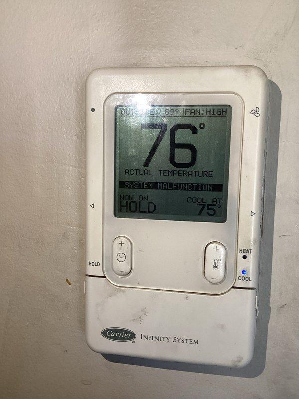 Responded to service call for AC not cooling properly and unusual odor. Upon arrival, found Carrier Infinity System thermostat displaying "SYSTEM MALFUNCTION" error with unit running but failing to reach setpoint of 75°F, with actual temperature reading 76°F and outside temperature at 89°F. Diagnosed system malfunction, cleared error codes, and restored proper cooling operation. Verified thermostat communication with air handler, confirmed fan operation on high speed, and ensured system cycling correctly to maintain desired temperature setpoint.