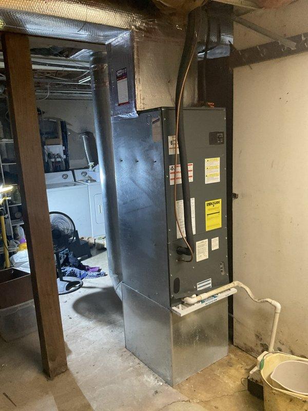 Completed HVAC system replacement estimate for 15-year-old equipment experiencing inadequate cooling performance. Assessed existing indoor air handler unit located in basement mechanical room and outdoor condensing unit positioned on concrete pad against foundation, documented current system configuration including ductwork connections and electrical service, and provided replacement recommendations to restore proper climate control functionality.