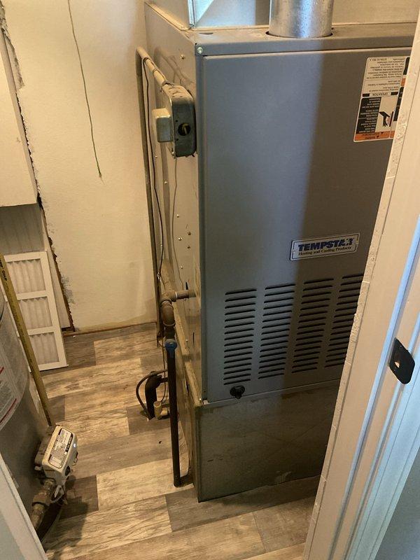 Responded to service call for non-operational HVAC system. Upon arrival, inspected existing Tempstar furnace unit installed in utility area and evaluated overall system condition including ductwork, ventilation components, and air return grille. Documented equipment specifications and installation configuration to provide comprehensive replacement estimate for new heating and cooling system.