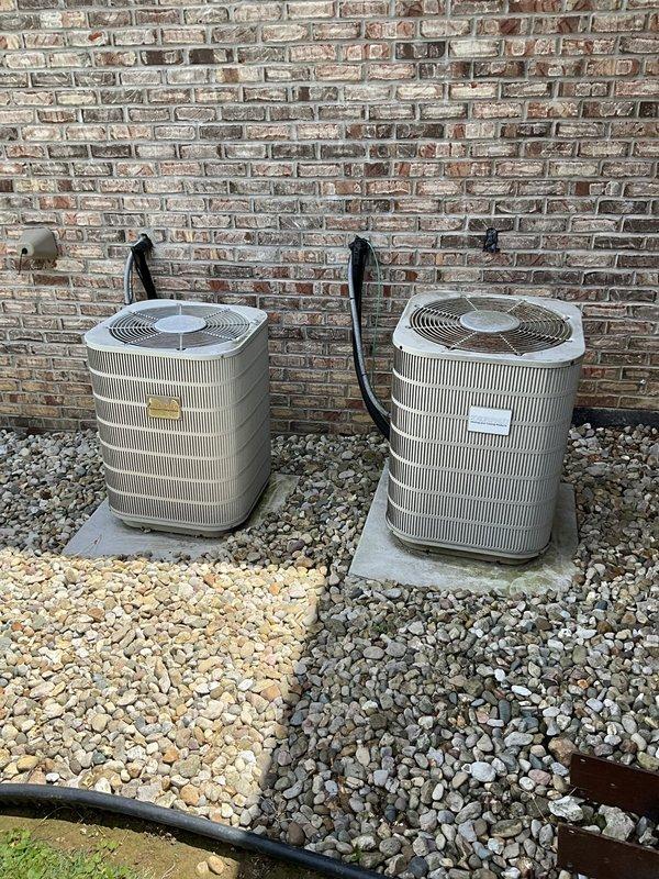 Responded to service call for dual-zone split system with one non-operational unit. Performed on-site assessment of 20-year-old equipment including two outdoor condensing units and indoor air handlers with furnace. Documented existing system configuration with two beige condenser units positioned on concrete pads against exterior brick wall, along with basement-mounted furnace and air handler setup. Provided comprehensive replacement estimate with multiple brand options per customer request, as previous contractor offered limited equipment selection.