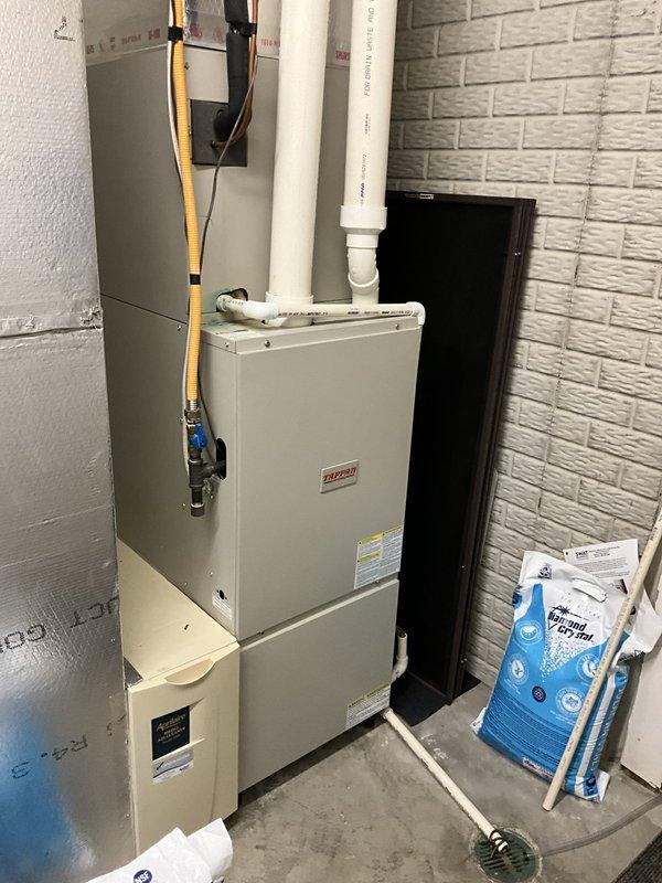Responded to service call for dual-zone split system with one non-operational unit. Performed on-site assessment of 20-year-old equipment including two outdoor condensing units and indoor air handlers with furnace. Documented existing system configuration with two beige condenser units positioned on concrete pads against exterior brick wall, along with basement-mounted furnace and air handler setup. Provided comprehensive replacement estimate with multiple brand options per customer request, as previous contractor offered limited equipment selection.