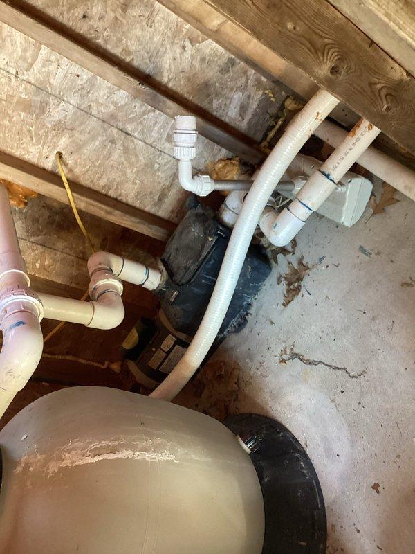 Responded to service call for inground pool heating system with reported leak. Upon inspection, discovered significant water damage to wooden structural elements in basement/mechanical area, with deteriorated OSB sheathing indicating prolonged moisture exposure. Documented existing plumbing infrastructure including PVC drainage lines, copper supply lines, and utility equipment to assess leak source and potential HVAC system impacts related to pool heater installation.