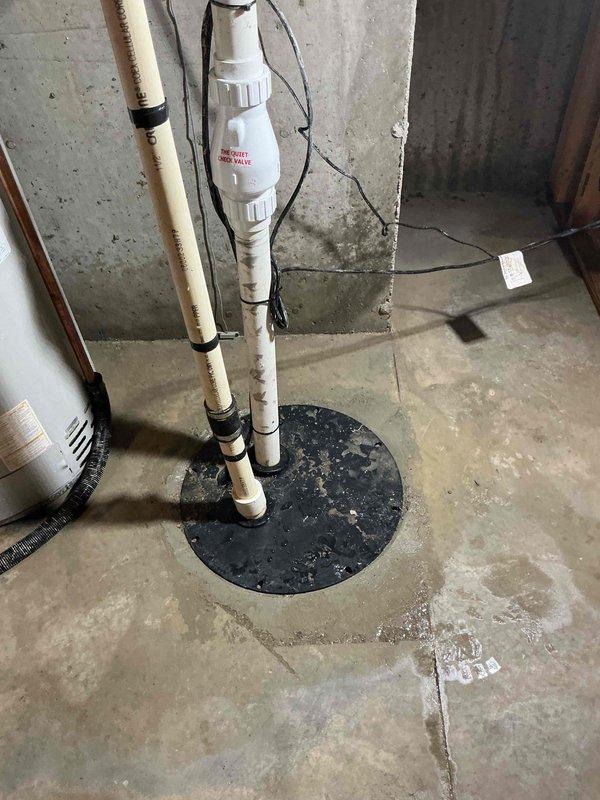 Completed replacement of existing sump pit installation in concrete basement floor, including removal of old pit and installation of new sump basin with pump assembly. Installed new PVC discharge piping system with appropriate check valve and secured all vertical piping to ensure proper drainage function. Connected electrical wiring to pump unit and verified operational performance, ensuring proper float switch activation and discharge capacity to protect basement from water intrusion.