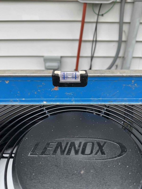 Completed full HVAC system installation consisting of Lennox air conditioning unit and furnace at residential property. Installed outdoor condensing unit on ground-level pad with proper leveling verified using precision instruments, secured refrigerant lines and electrical conduit to exterior wall per manufacturer specifications. Routed PVC condensate drain through roof penetration with appropriate rubber boot flashing to ensure weatherproof seal, installed furnace system with all necessary venting and drainage connections to complete integrated heating and cooling system.