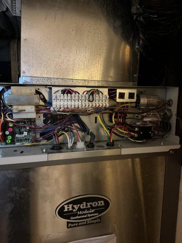 Completed monthly basic cooling maintenance visit on Hydron Module geothermal system. Performed standard preventive maintenance procedures including system inspection, verified thermostat operation displaying 74°F, examined internal components and electrical connections, checked control board indicator lights, and replaced 20x25x4 air filter. All components operating within normal parameters; noted condensation present on wall surface near unit, which is typical for geothermal system operation in cooling mode.