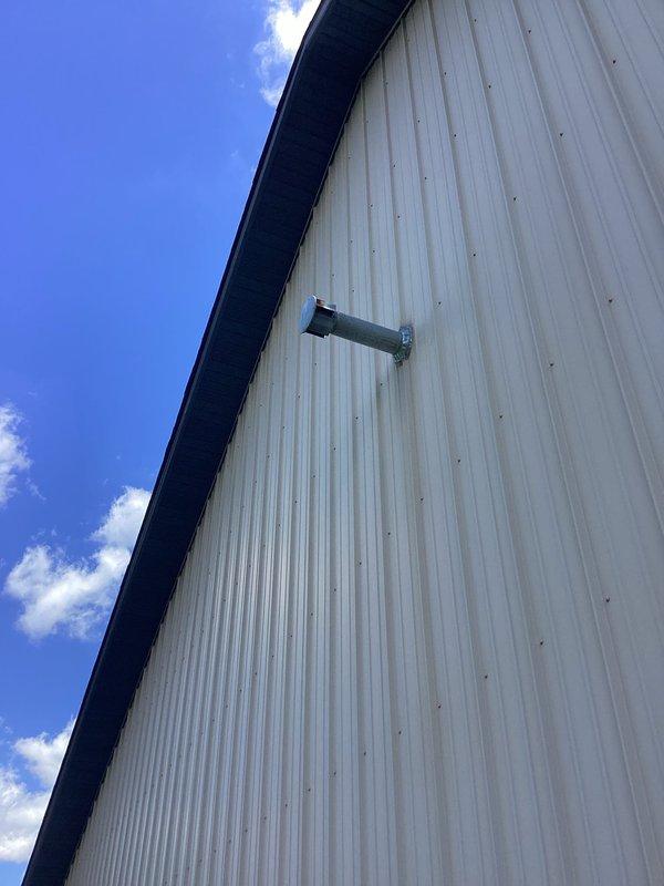 Completed trouble call for detached pole barn structure with compromised HVAC ventilation system. Multiple outlet vents had become dislodged from flexible aluminum ductwork running along upper wall/ceiling area, creating openings that allowed pest intrusion. Documented existing conditions showing exposed ductwork and missing vent terminations on both interior and exterior building surfaces. Provided estimate for reinstallation and securing of displaced vents to restore proper system integrity and prevent further wildlife entry.