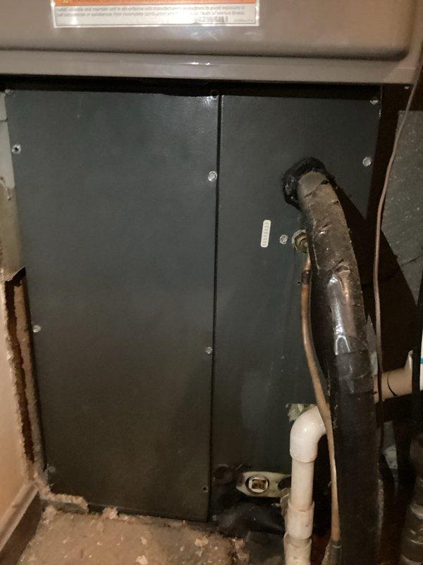 Responded to complaint of no airflow to back room following recent ductwork modifications. Inspected HVAC system and ductwork in mechanical space, verified thermostat operation showing 75°F display with proper system controls. Investigated duct access panel and associated supply lines to identify airflow restriction or disconnection affecting the back room zone.