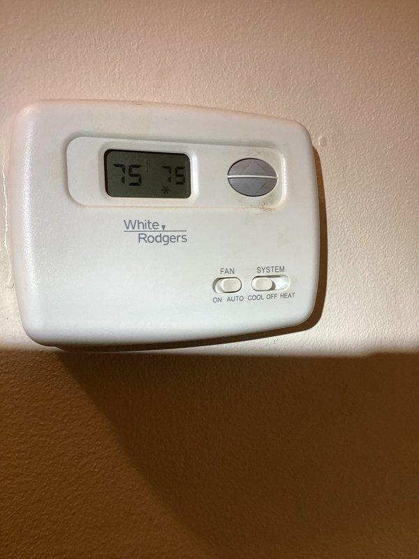 Responded to complaint of no airflow to back room following recent ductwork modifications. Inspected HVAC system and ductwork in mechanical space, verified thermostat operation showing 75°F display with proper system controls. Investigated duct access panel and associated supply lines to identify airflow restriction or disconnection affecting the back room zone.