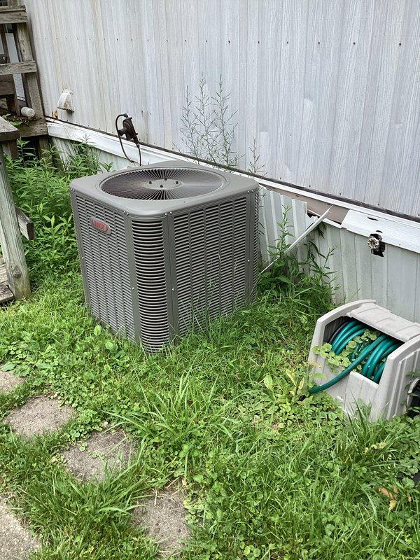 Completed preventative maintenance on residential split HVAC system under comfort club agreement. Serviced outdoor condenser unit and indoor air handler, replaced 16x20x1 air filter, and performed standard cooling season inspection. Noted vegetation overgrowth around outdoor unit requiring clearance for optimal airflow and efficiency.