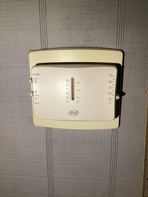 Responded to service call for non-functional air conditioning system at residential property. Upon arrival, performed comprehensive diagnostic inspection of existing Goodman HVAC system installation located in utility area. Evaluated furnace unit, refrigerant line connections, ductwork sealing, and thermostat operation. Inspected copper refrigerant lines and verified proper connection integrity at furnace interface. Examined aluminum foil tape applications on ductwork joints for air leakage. Assessed wall-mounted Hunter thermostat functionality, verifying proper wiring connections and system control settings including cooling, heating, and fan operation modes. System restored to normal operating condition following diagnostic evaluation and necessary adjustments.