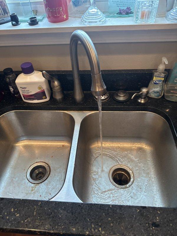 Responded to service call for garbage disposal backing up into dishwasher. Upon inspection, diagnosed improper drainage connection between disposal unit and dishwasher discharge line causing wastewater to reverse flow into dishwasher during disposal operation. Cleared blockage in disposal discharge pipe and verified proper drainage flow through both sink basins. Tested garbage disposal operation and confirmed dishwasher drain line functioning correctly with no backflow issues. System restored to normal operation.