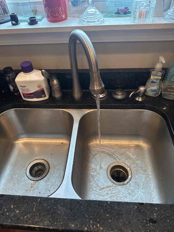 Responded to service call for garbage disposal backing up into dishwasher. Upon inspection, diagnosed improper drainage connection between disposal unit and dishwasher discharge line causing wastewater to reverse flow into dishwasher during disposal operation. Cleared blockage in disposal discharge pipe and verified proper drainage flow through both sink basins. Tested garbage disposal operation and confirmed dishwasher drain line functioning correctly with no backflow issues. System restored to normal operation.