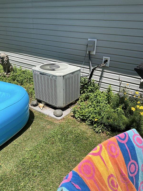 Conducted comprehensive assessment of existing HVAC system for replacement estimate. Evaluated outdoor Trane condenser unit mounted on concrete pad with associated refrigerant lines, electrical disconnect, and line set routing along exterior wall. Inspected indoor Trane air handler installation in utility area, including ductwork connections, condensate drain system, and electrical service. Documented current equipment specifications, installation configuration, and clearances to provide accurate replacement recommendations for complete system upgrade.