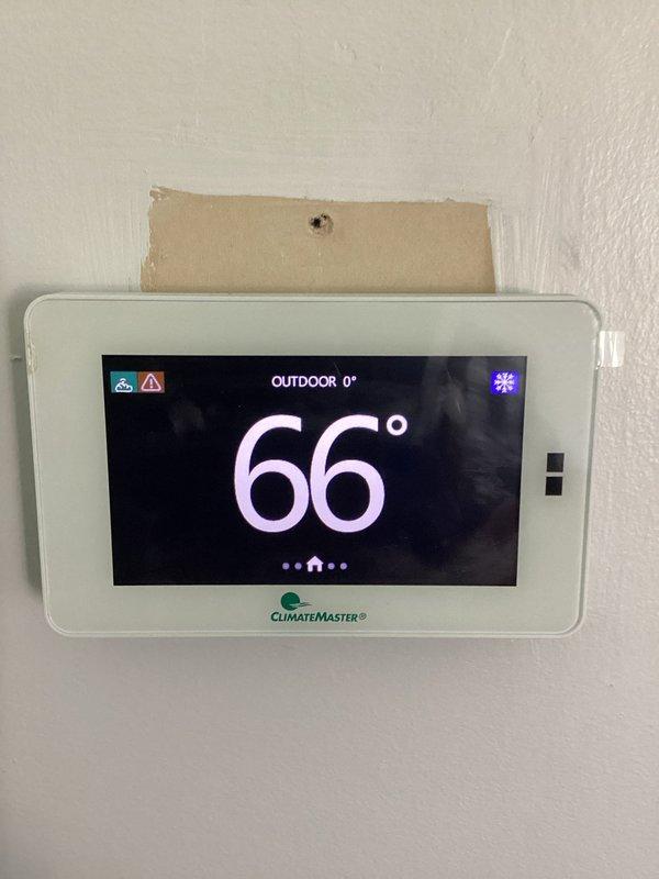 Responded to no cooling complaint with thermostat alert on ClimateMaster geothermal system. Performed system diagnostics and vacuum pressure testing to verify refrigerant circuit integrity and proper system operation. Confirmed unit returned to normal cooling function with thermostat displaying 66° and system operating without alerts.