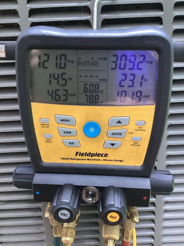 Performed leak detection on R454B refrigerant system using electronic leak detector but was unable to locate source of refrigerant loss. Monitored system pressures with manifold gauges showing 72.0 PSIG suction and 309.2 PSIG discharge with 145°F superheat and 23°F subcooling. Scheduled follow-up visit in one to two weeks to perform UV dye leak detection scan to identify leak location.