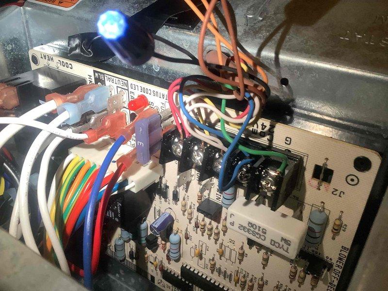 Responded to service call for thermostat malfunction reported over several days. Performed diagnostic inspection of HVAC system including control board, wiring connections, and electrical components. Verified proper operation of furnace control module, checked status indicator LED function, inspected wire terminal connections at control board, and examined blower motor assembly and compressor unit for proper integration with thermostat controls.