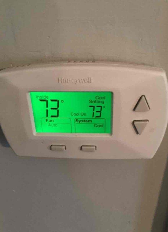 Completed basic monthly cooling maintenance visit on residential HVAC system. Inspected Honeywell digital thermostat confirming proper operation with system cooling at 73 degrees setpoint, verified fan and system controls functioning in auto mode. Performed exterior inspection of condenser unit, checked fan grille and louver condition, confirmed unit operational with no visible refrigerant leaks or mechanical issues, and replaced 16x25x1 air filter per maintenance agreement.