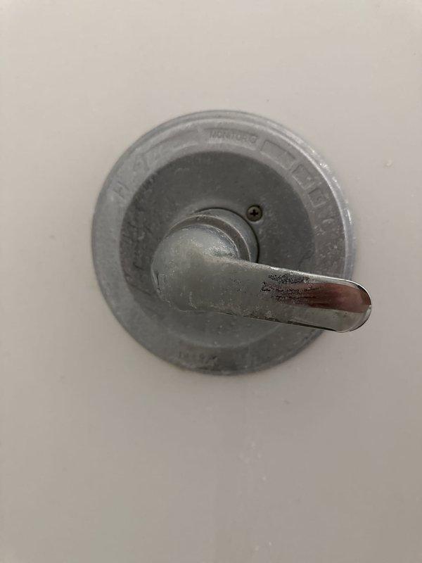 Responded to service call for constantly dripping showerhead in residential bathroom. Upon arrival, inspected chrome-finished showerhead assembly and shower valve system. Identified worn internal washer and deteriorated O-ring seals within the shower valve mechanism causing persistent drip. Disassembled showerhead from wall-mounted arm fitting and inspected for mineral buildup and component wear. Replaced faulty washers and seals, cleaned aerator screen, and reassembled unit. Tested water flow and verified complete elimination of drip. Inspected surrounding shower area and noted pre-existing wall damage near ceiling line unrelated to plumbing issue. All fixtures restored to proper working order with no leaks detected.