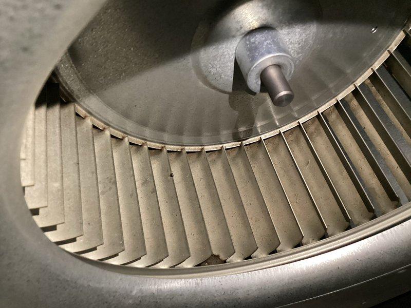 Completed annual basic cooling maintenance visit on CCHP system. Inspected blower wheel assembly, noting significant dust accumulation on squirrel cage fan blades and housing that required attention during routine maintenance. Performed electrical diagnostics using digital multimeter, recording amperage draw of 0.66A to verify proper blower motor operation and system performance within manufacturer specifications.