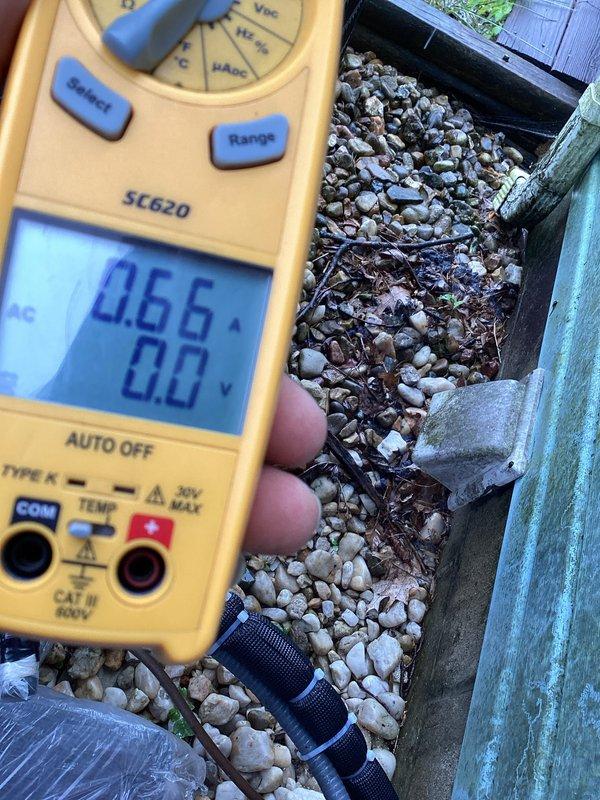 Completed annual basic cooling maintenance visit on CCHP system. Inspected blower wheel assembly, noting significant dust accumulation on squirrel cage fan blades and housing that required attention during routine maintenance. Performed electrical diagnostics using digital multimeter, recording amperage draw of 0.66A to verify proper blower motor operation and system performance within manufacturer specifications.