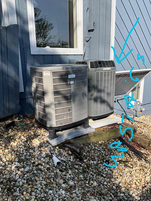 Conducted cooling system assessment for residential property with inadequate cooling capacity. Evaluated existing dual outdoor condensing unit configuration, including Bryant cylindrical unit and secondary beige condensing unit, both mounted on concrete pads with proper drainage base. Documented current equipment specifications, refrigerant line routing, electrical conduit installations, and mounting configurations to determine replacement requirements for improved cooling performance.