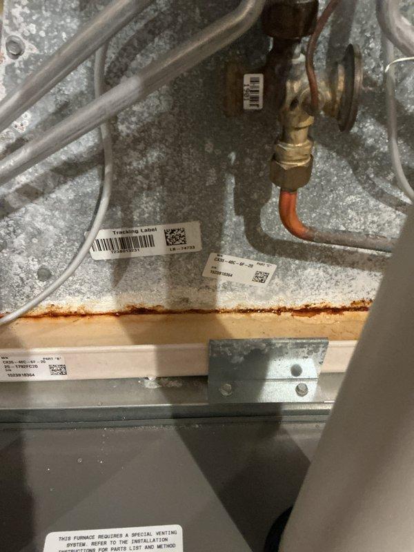 Completed annual basic cooling maintenance visit on Lennox HVAC system. Performed comprehensive inspection of furnace and cooling components, including examination of internal mechanical and electrical systems, refrigerant lines, and brass fittings with copper connections. Observed rust/corrosion staining on interior metal housing seam requiring monitoring for future service intervals. Verified thermostat operation and system functionality, confirming proper temperature control at 75°F setpoint. All system components operational upon completion of preventive maintenance protocol.