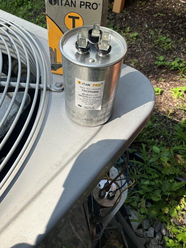 Replaced failed run capacitor on outdoor condensing unit with new TITAN PRO TRCFD455 capacitor. Removed old weathered capacitor and installed new unit, restoring proper compressor and fan motor operation. System tested and confirmed operating within normal parameters.