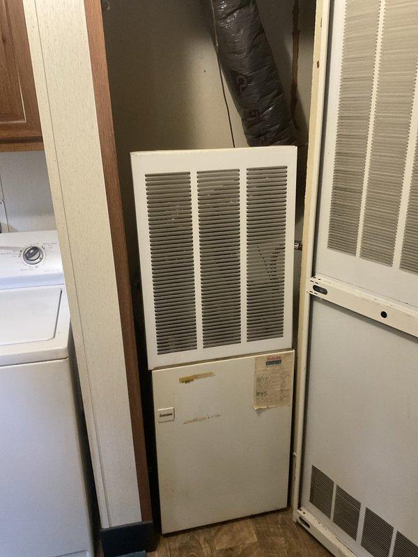 Completed full system replacement estimate for aging 4-ton R22 Ducane HVAC system experiencing low refrigerant levels and inadequate cooling performance. Evaluated existing vertical air handler installation in utility closet and outdoor condenser unit, both showing signs of age and operating with obsolete R22 refrigerant. Documented equipment specifications, measured system capacity requirements, photographed current installations, and provided comprehensive replacement options to address refrigerant phase-out concerns and restore reliable climate control to the residence.