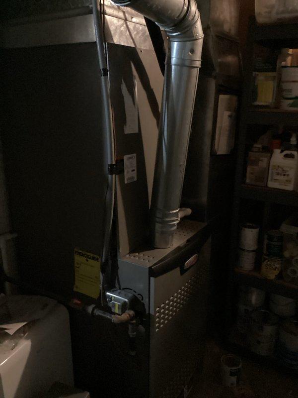 Performed free second opinion inspection of residential forced-air furnace following report of cracked heat exchanger from another contractor. Conducted thorough visual inspection of furnace cabinet and heat exchanger assembly using camera equipment to verify condition and document findings. System currently operational with thermostat displaying heating mode at set point, no immediate safety concerns identified during inspection.
