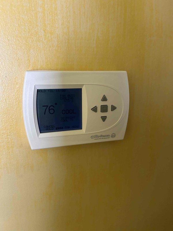 Responded to cooling complaint for upstairs unit. Inspected Carrier air handler system and verified thermostat operation showing 76°F on hold setting in cooling mode. Performed diagnostic evaluation of equipment and ductwork to identify cause of inadequate cooling performance.
