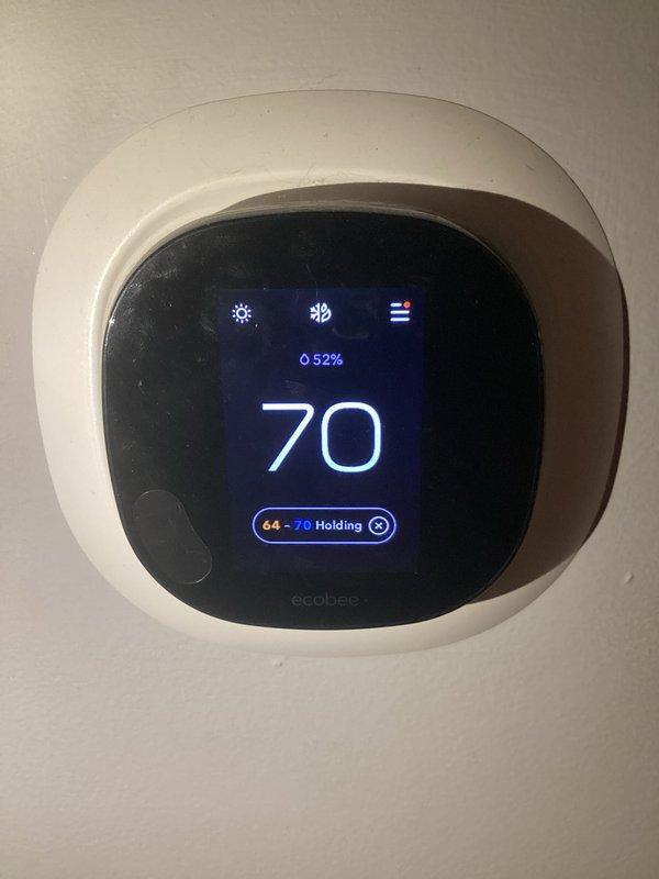 Completed routine HVAC maintenance and cooling system inspection. Verified ecobee smart thermostat operation displaying 70°F with 52% humidity and holding setpoint between 64-70°F. Installed new 20×20×1 pleated air filter and documented filter size for future service reference.