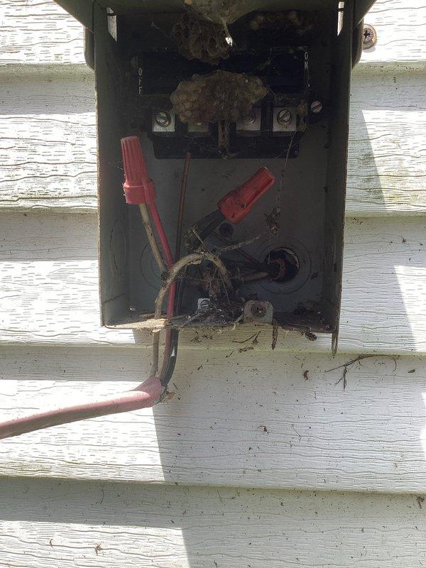 Responded to no cooling complaint with warm air discharge from supply registers. Upon arrival, found thermostat displaying error code and outdoor disconnect junction box with deteriorated wiring connections. Inspected thermostat operation and outdoor electrical connections. Documented existing conditions showing compromised wire terminations and debris accumulation in exterior junction box affecting system operation.