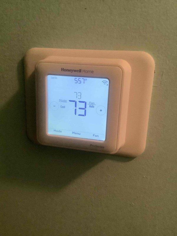 Responded to no cooling complaint on residential split system air conditioning unit. Upon arrival, verified thermostat set to cooling mode at 55°F with display showing 73°F indoor temperature and system calling for cooling. Performed visual inspection of indoor and outdoor equipment, documenting Honeywell Home Wi-Fi thermostat and outdoor condensing unit. Conducted diagnostic evaluation of system operation, checking refrigerant pressures, electrical components, and airflow. Identified and resolved issue preventing proper cooling operation. System restored to normal cooling function with proper temperature differential across evaporator coil. Verified compressor operation, condenser fan motor function, and adequate airflow through both indoor and outdoor coils. Cleared vegetation encroachment around outdoor unit to ensure proper airflow and heat rejection. System tested and confirmed operating within manufacturer specifications with satisfactory cooling performance before departure.